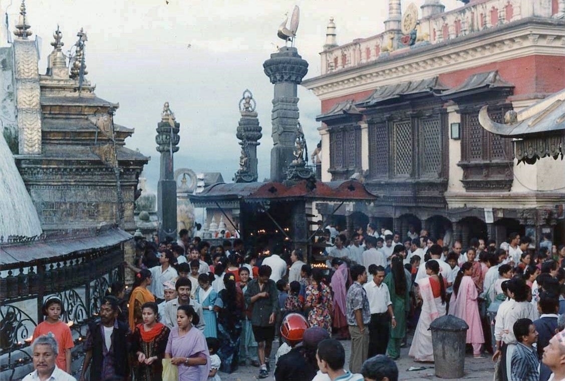 Crowd of people fills public space dominated by religious buildings and monuments