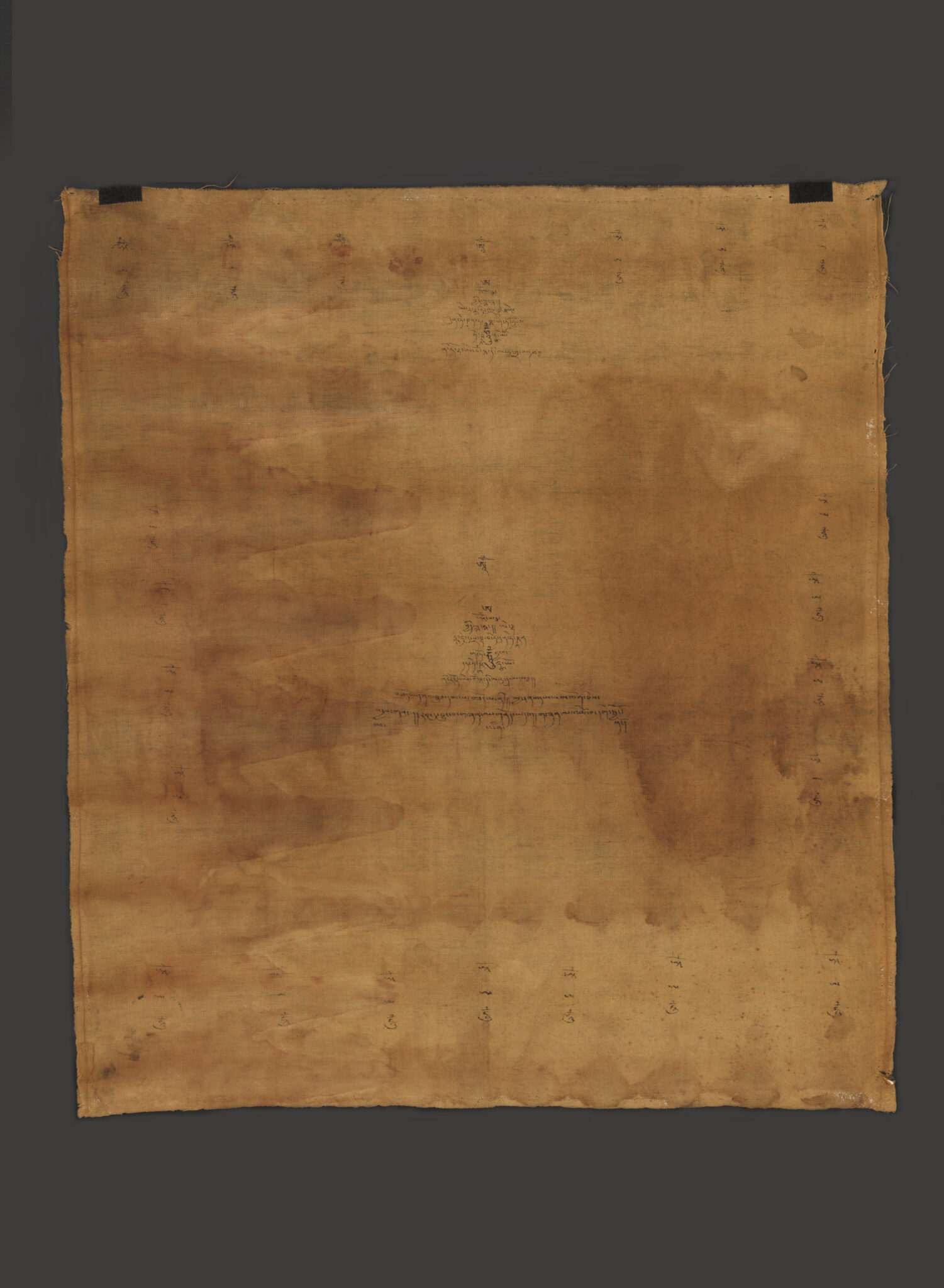 Sepia textile featuring pair of barely visible, blurry footprints and faint markings at center