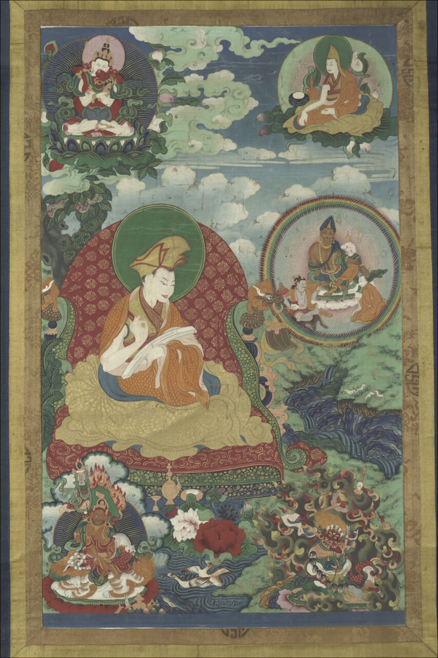 Lama seated on throne upholstered with red-and-gold brocade above two wrathful deities beneath three portraits