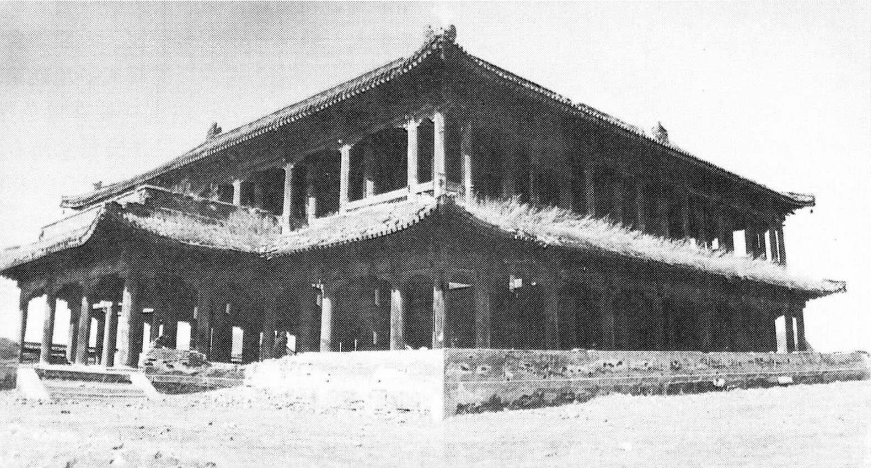 Black and white photograph of two-story, pagoda-roofed building featuring colonnades on both levels