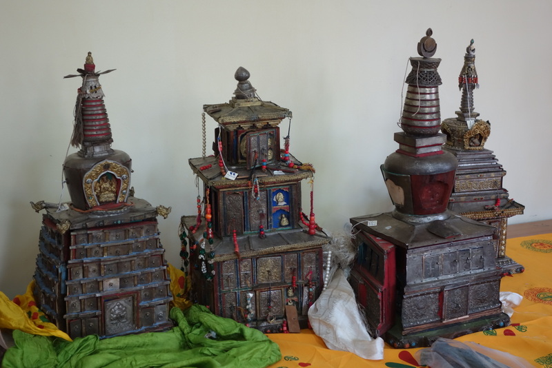 Four religious implements in the form of tiered buildings topped by stupas and canopies with doors closed