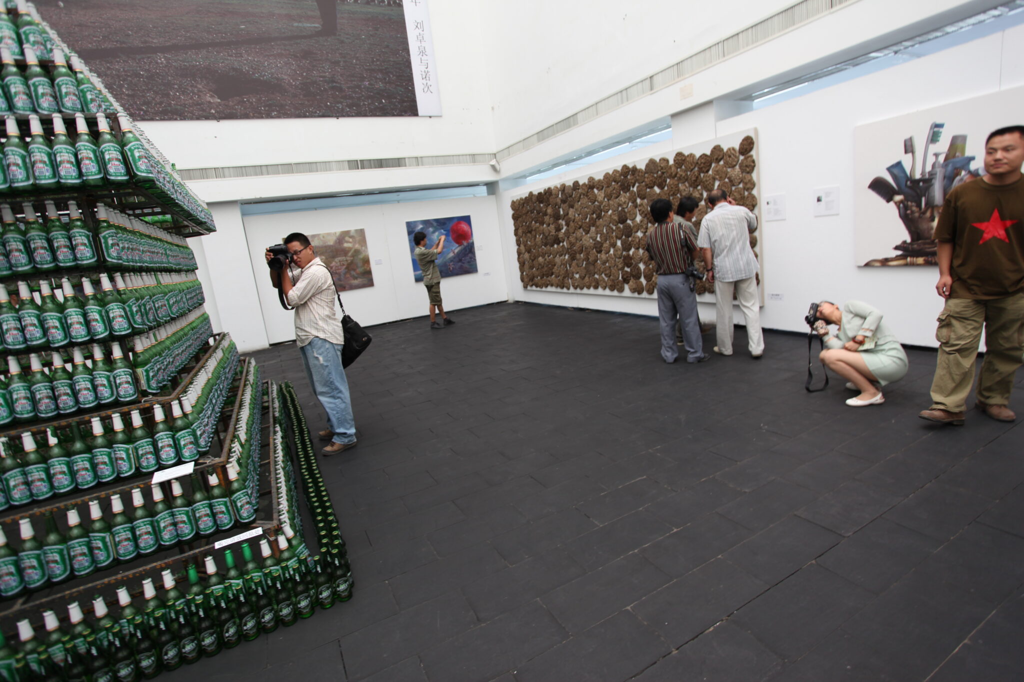 Photograph of visitors photographing and appreciating contemporary art in gallery setting