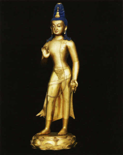 Golden Buddha with blue hair wearing diaphanous dhoti standing with left hand posed in mudra