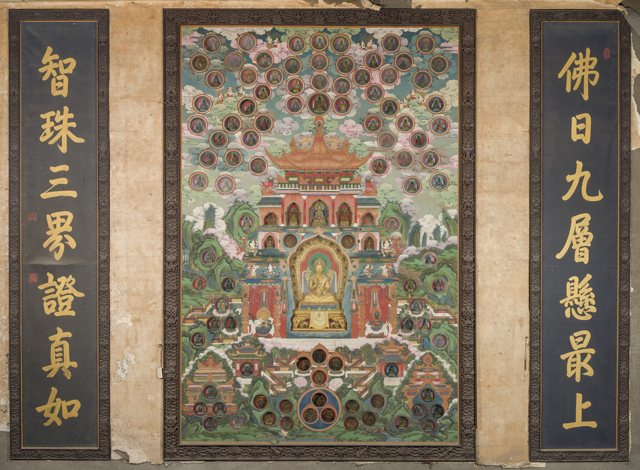 Painting depicting deity seated before ornate building, flanked by two framed sets of Chinese characters