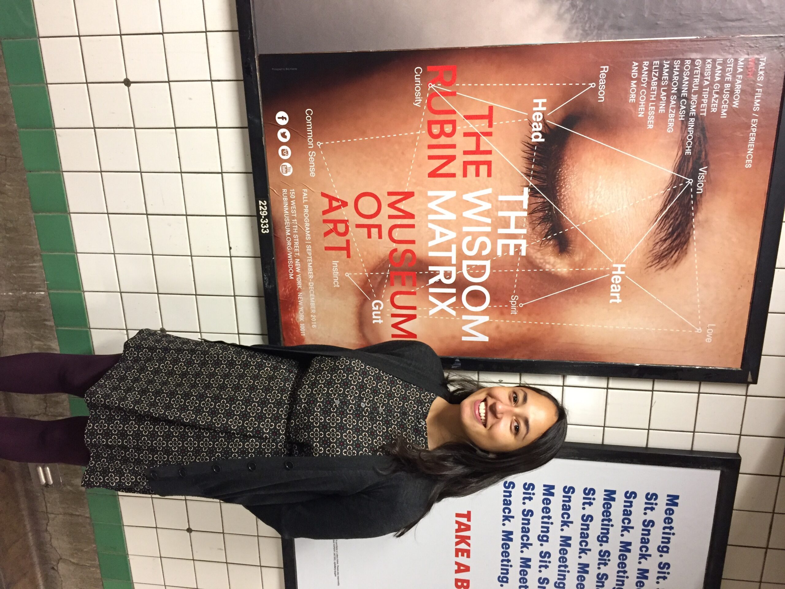 Laura in front of the Wisdom Matrix subway ad