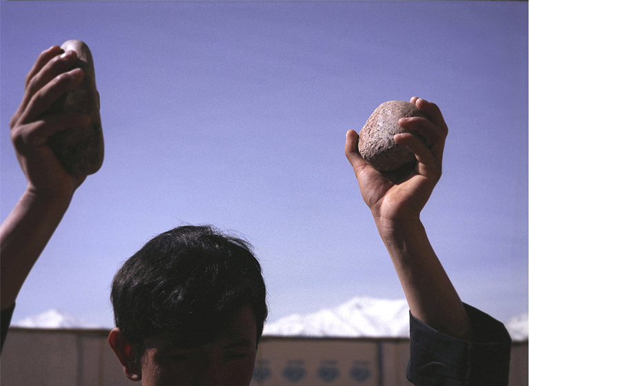 Lida Abdul (b. 1973, Kabul, Afghanistan; lives and works in Kabul and Los Angeles); still of Clapping With Stones; 2005; 16 mm film transferred to DVD; 5 min.; image courtesy of the artist and Giorgio Persano Gallery