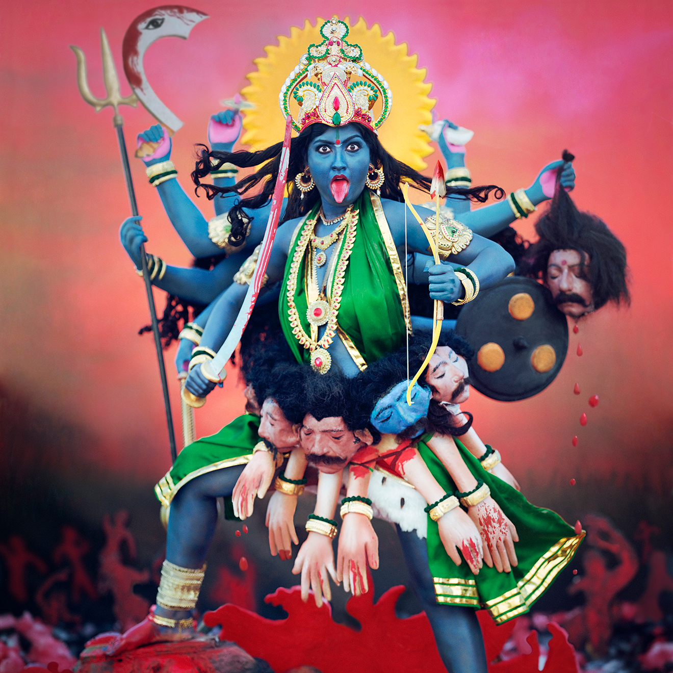 Bold, dramatic statue or tableau of the Hindu goddess Kali in a dynamic pose.