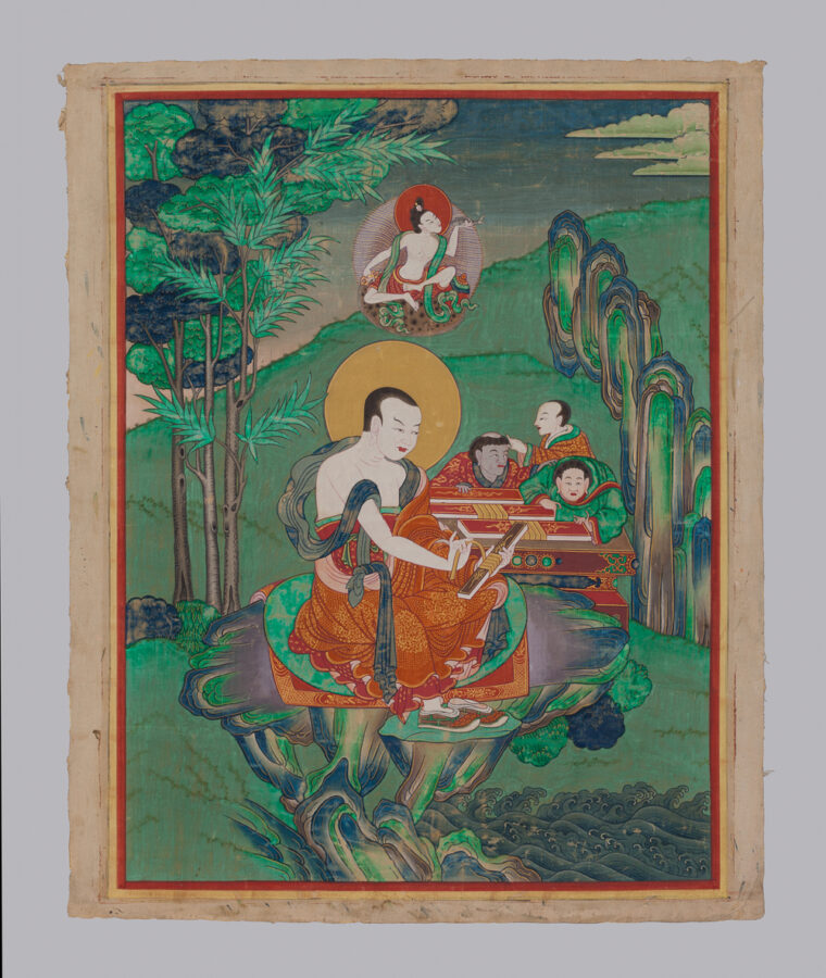 Thangka painting of a seated monk with a golden halo unwrapping a text, accompanied by two attendant figures, in a green landscape with stylized rocks, trees, and a small deity seated in clouds above.