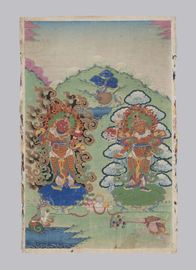Two richly dressed, bearded figures in armor face each other, both surrounded by swirling cloud motifs, against a backdrop of green hills, trees, and a body of water. Two smaller figures of attendants are placed at lower left and right, and a dish piled high with offerings sits between the two central figures.