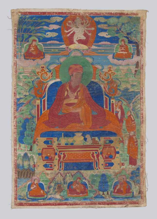 Thangka painting of a red-robed lama seated on an ornate throne, with a small multi-armed dancing deity above in a red aureole, flanked by seated figures on clouds, an altar table below, and additional seated figures at the bottom of the composition.