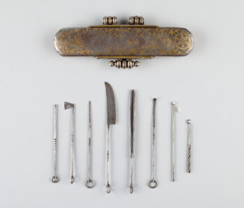 Golden case with silver implements below.