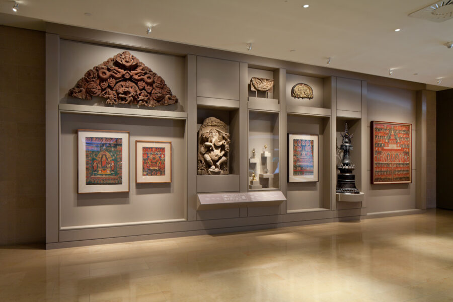 View of gallery showing multiple sculptures and paintings.