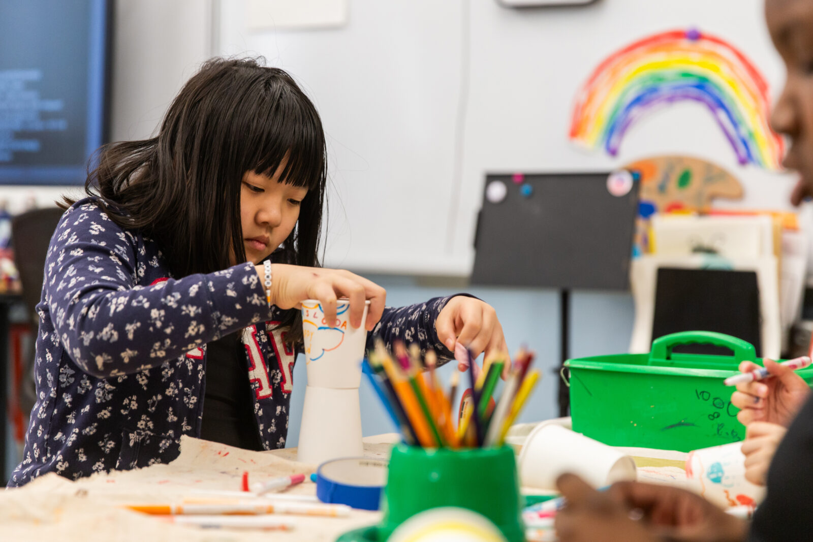 student concentrating on an artwork project in the classroom