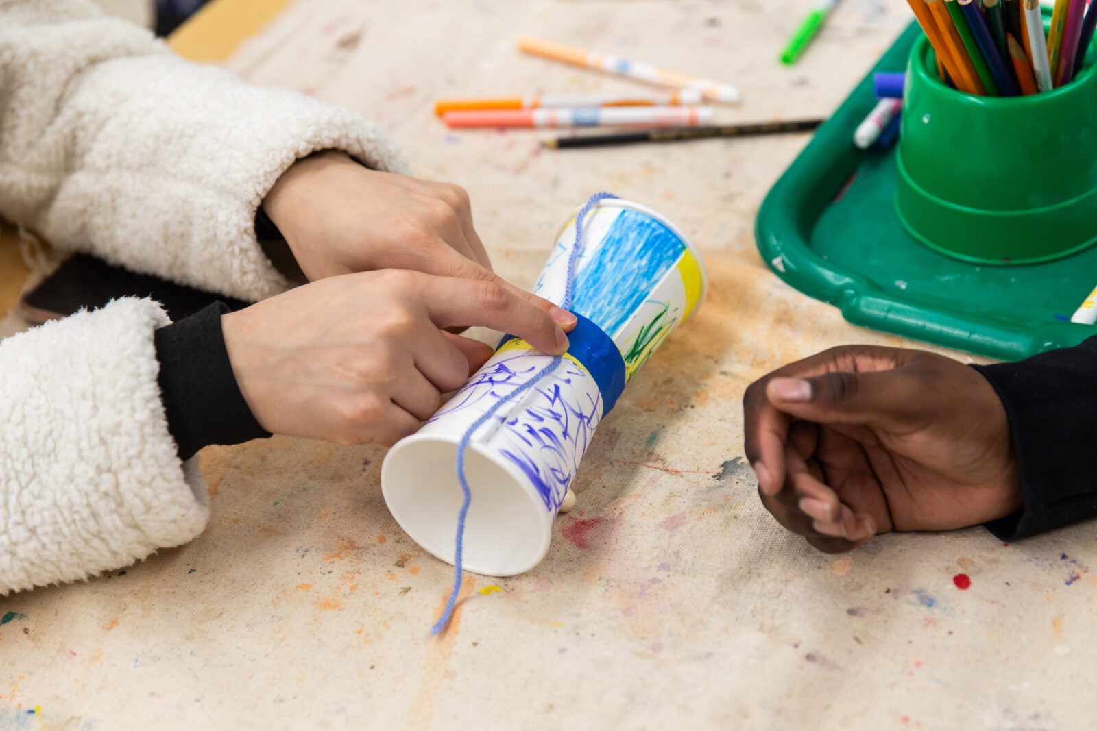 close-up of hands on their art project