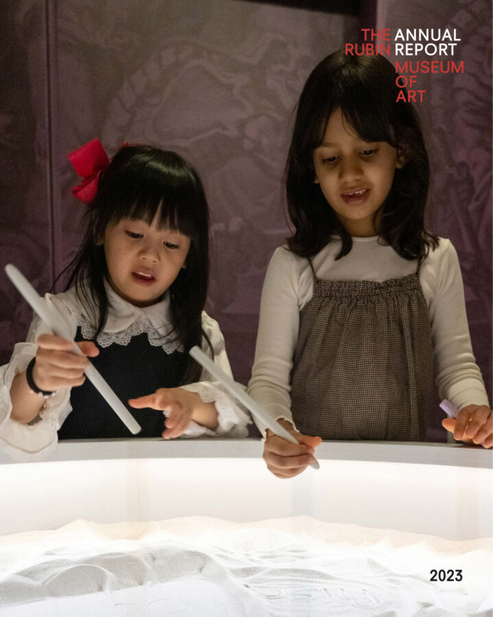 two children holding white sticks in front of white sand pit. "The Rubin Museum of Art Annual Report"