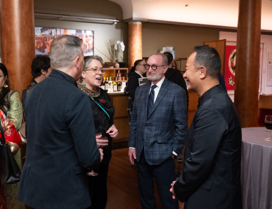 members of Rubin Museum board standing and speaking at an event