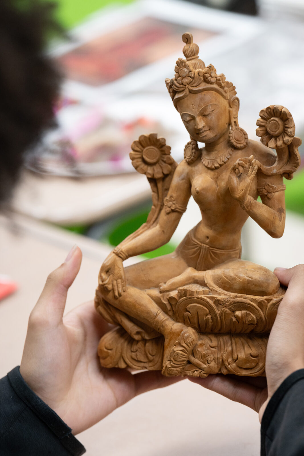 student hands holding an art object