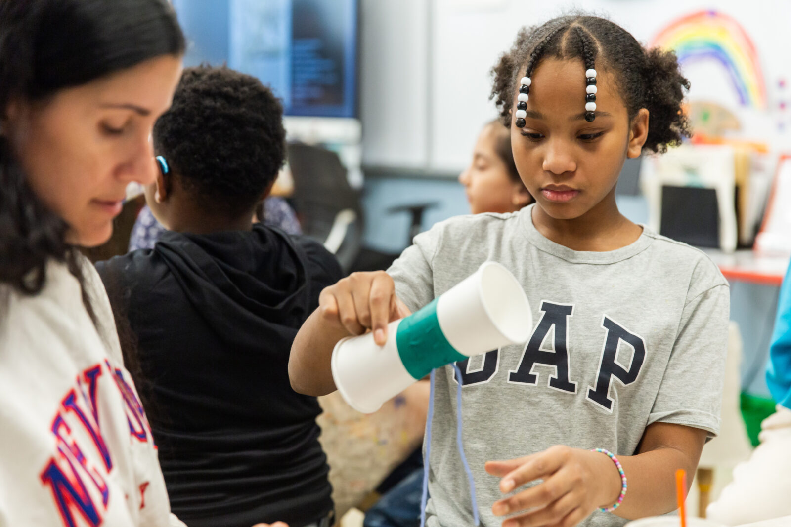 student holding an artwork in progress