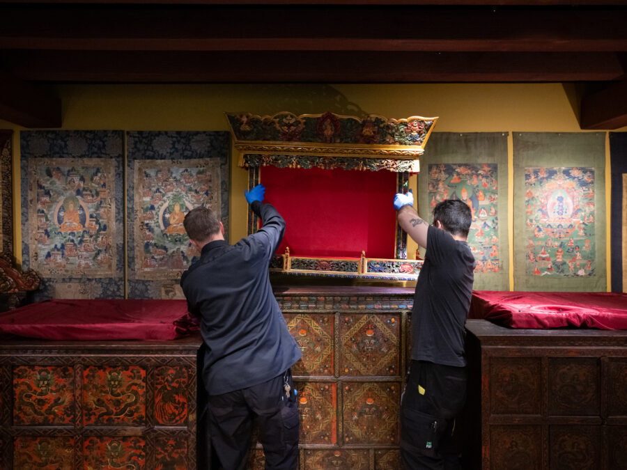 two adults installing the Rubin Museum Tibetan Buddhist Shrine Room