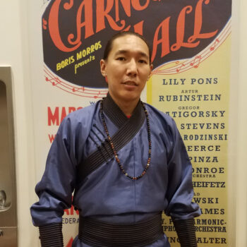 Bayarjargal Chogsom standing in front of a wall wearing a blue shirt