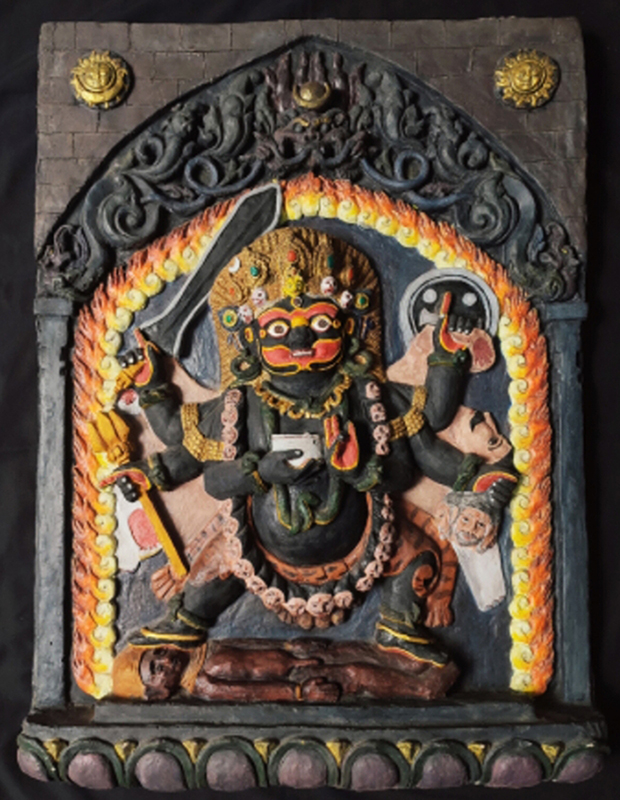 Statue of Kaal Bhairava surrounded by red, orange, and yellow flames