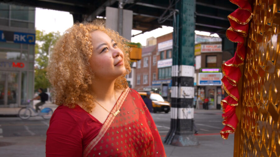 IMAGINE (a.k.a. Sneha Shrestha) looking at her sculpture in Diversity Plaza