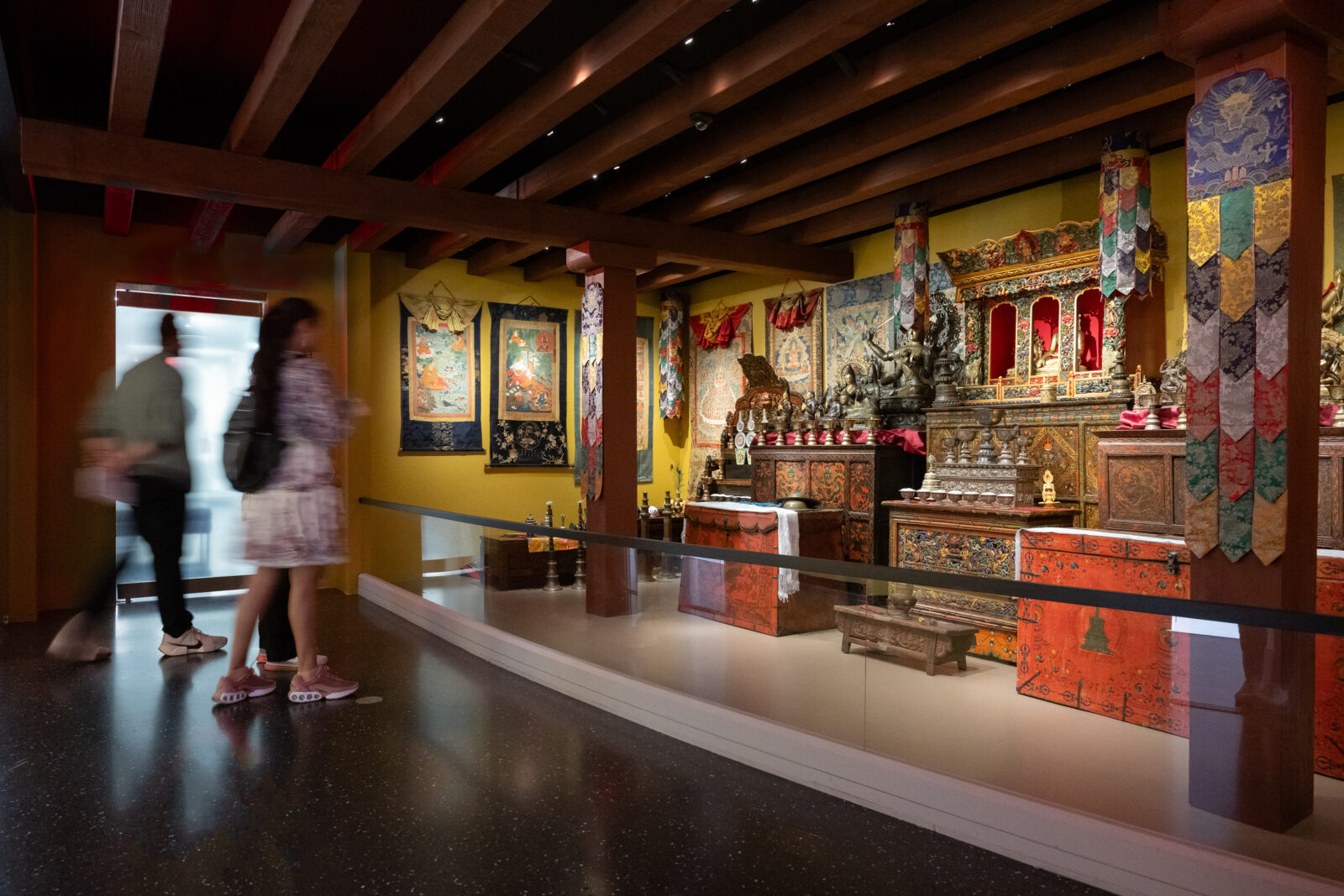 a visitor looks on at the Rubin Museum Tibetan Buddhist Shrine Room