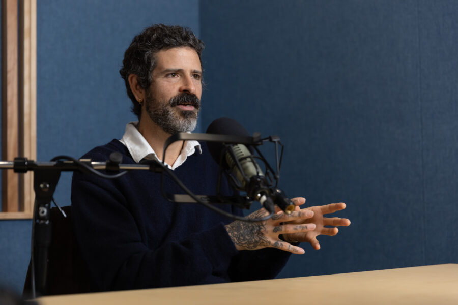 devendra banhart talking in front of a microphone