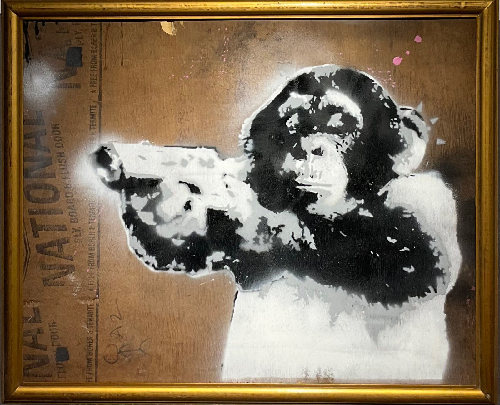 A framed black and white stencil-style painting of a chimpanzee pointing a gun towards the viewer