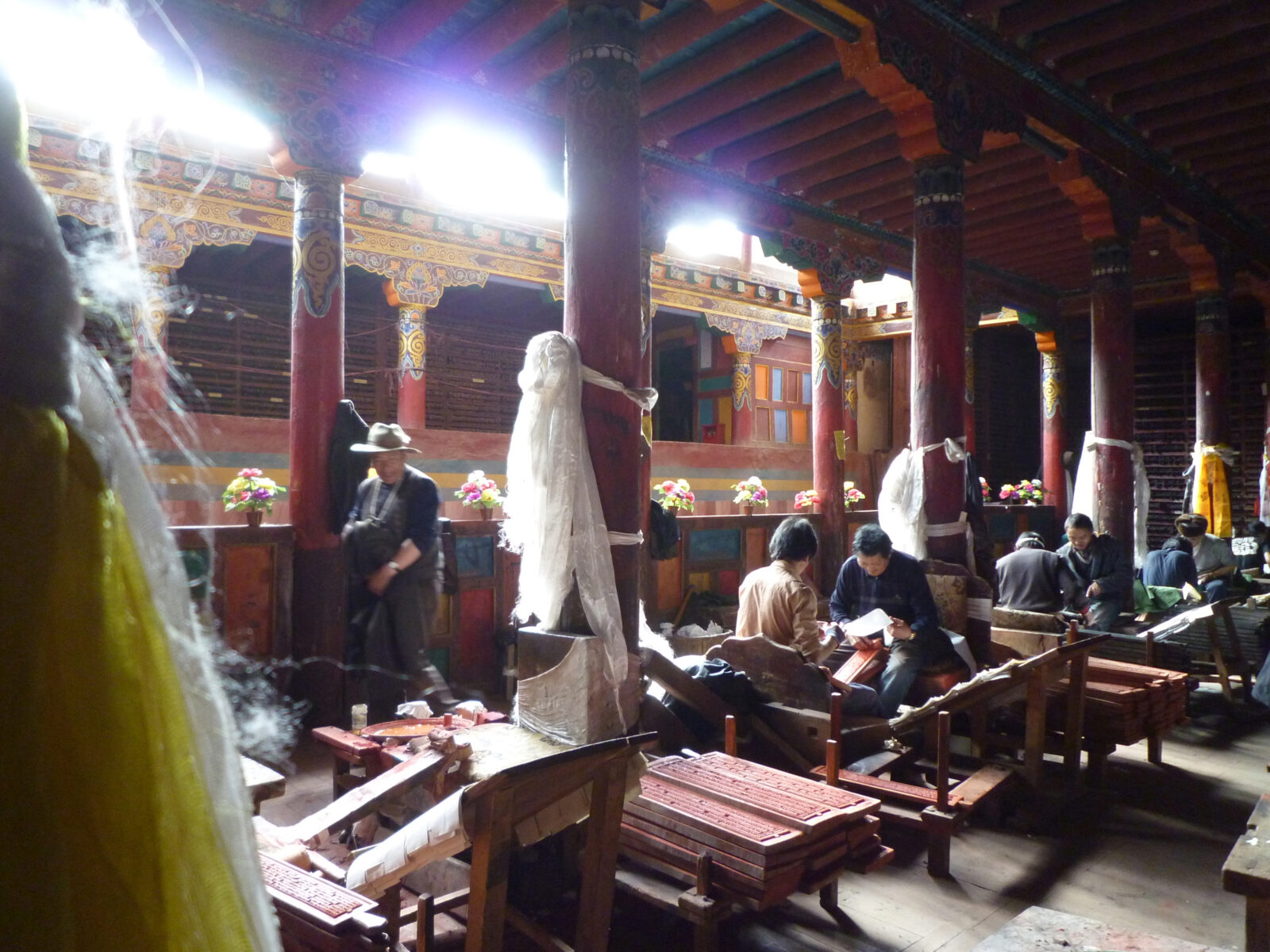 craftspeople inside a building making prints from woodblocks