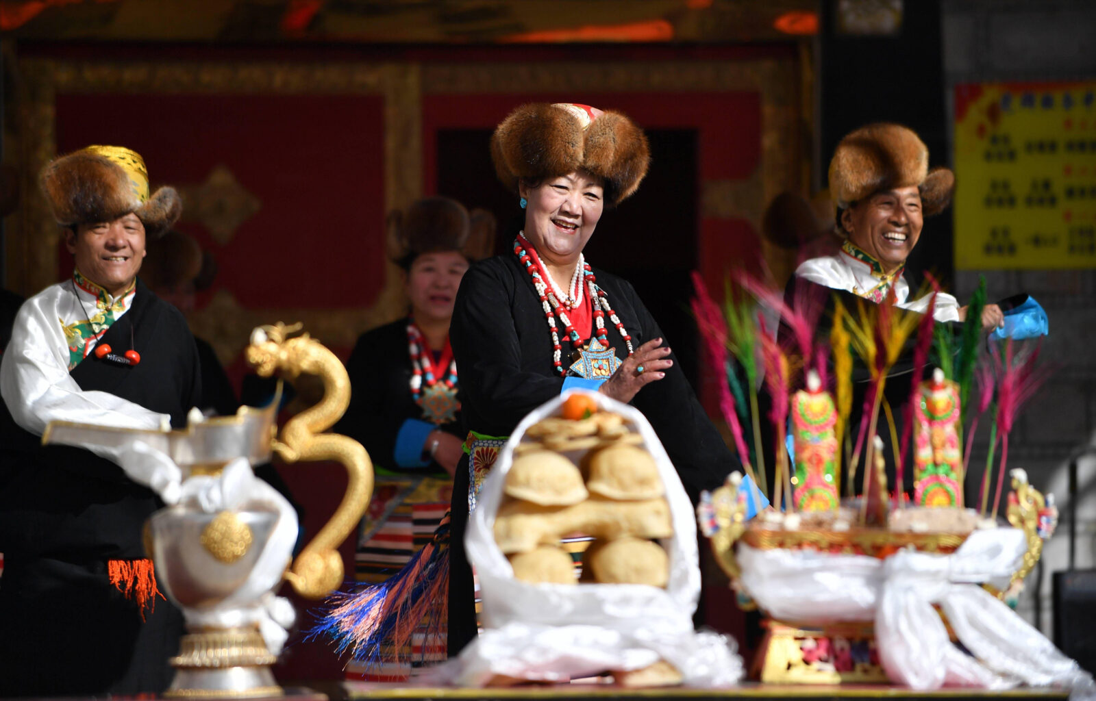 Tibetans wearing traditional dress celebrate Losar with fried pastries and roasted barley flower