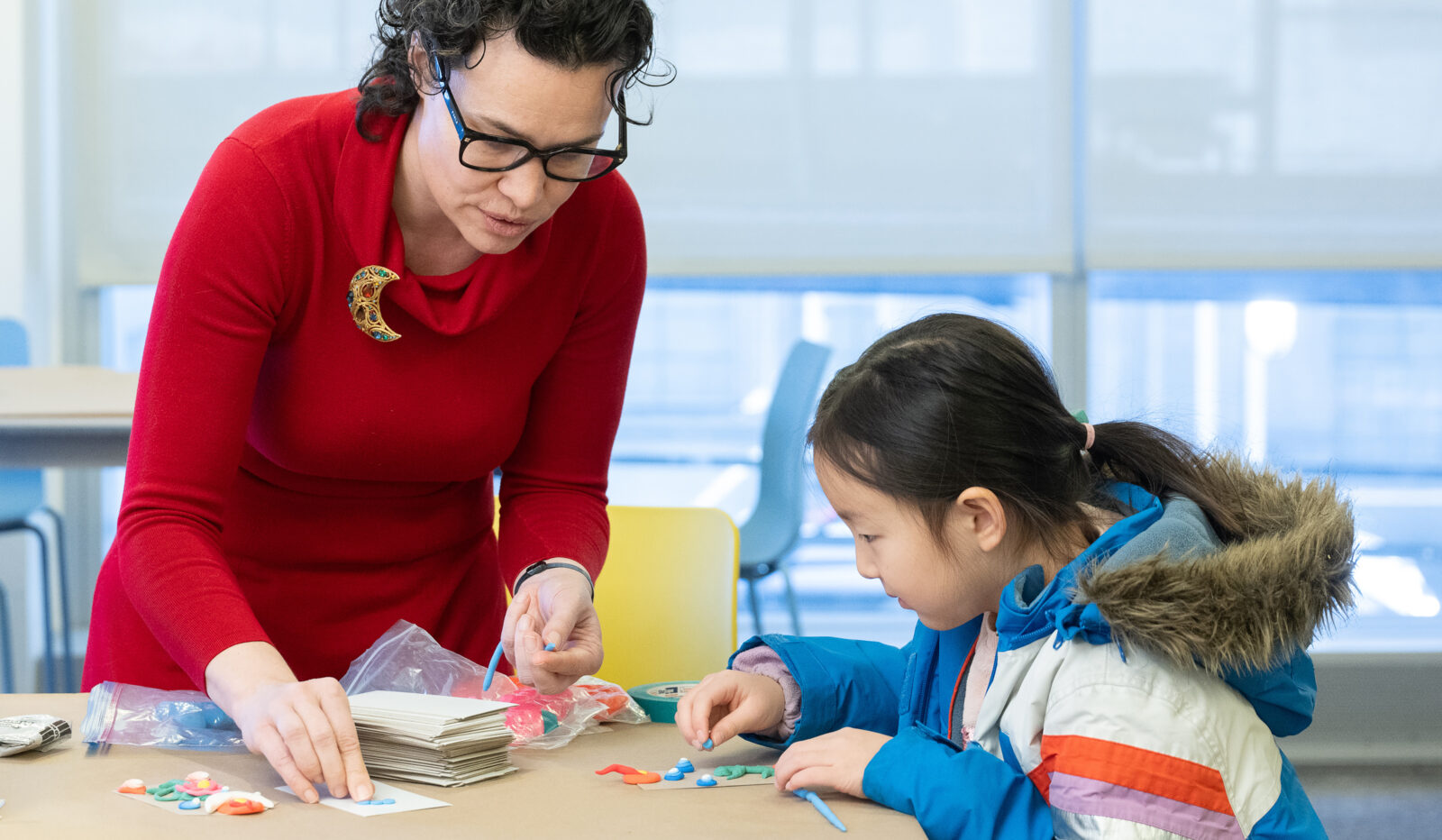 rubin teaching artist instructing a child in an art activity