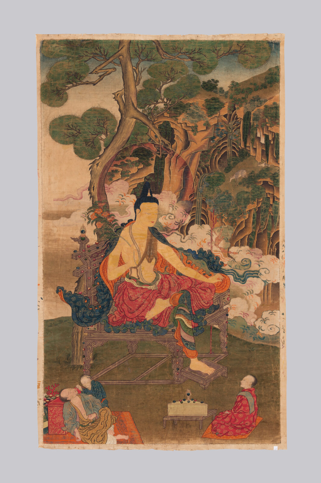 Painting of large figure with colorful robes seated on wooden platform with landscape in background and three smaller figures in foreground.