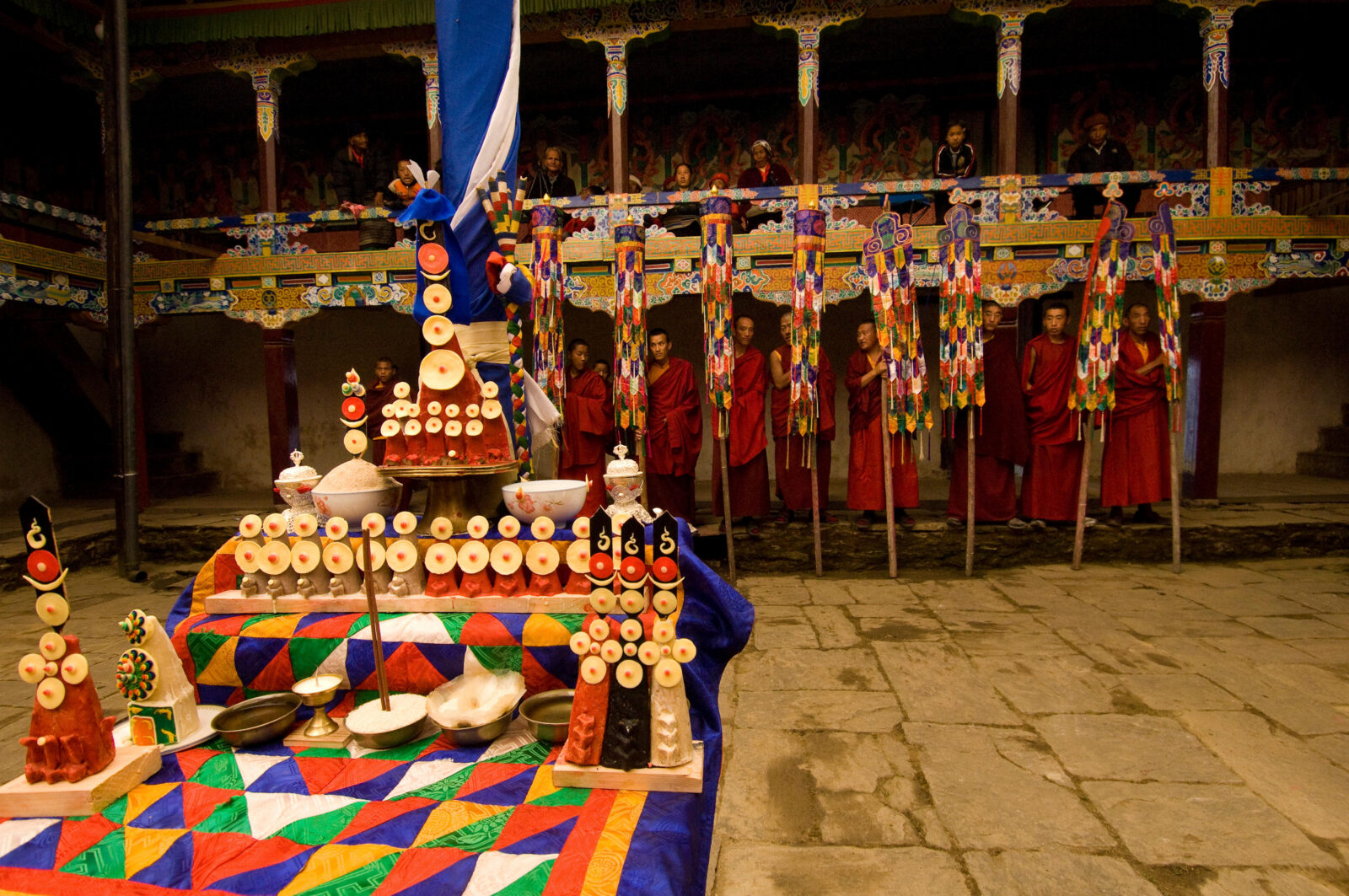 Monks in Nepal consecrate an altar with assorted tormas during the Mani Rimdu festival