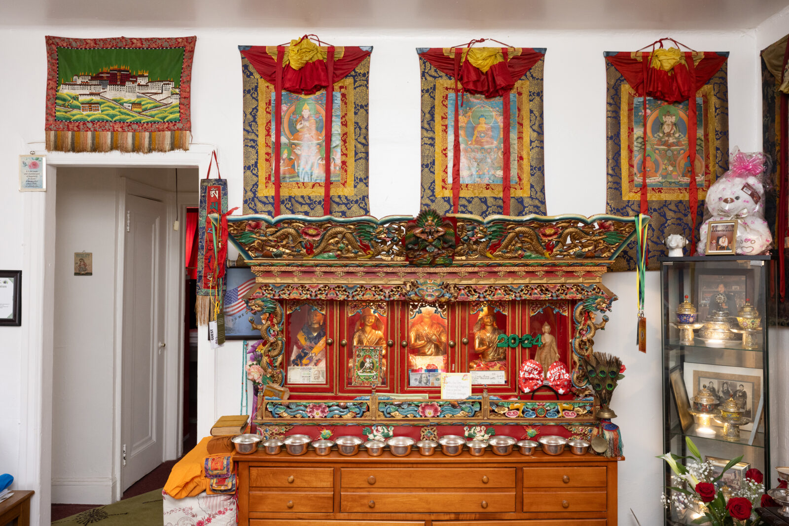 personal shrine room with thangkas, sculptures, and ritual artifacts