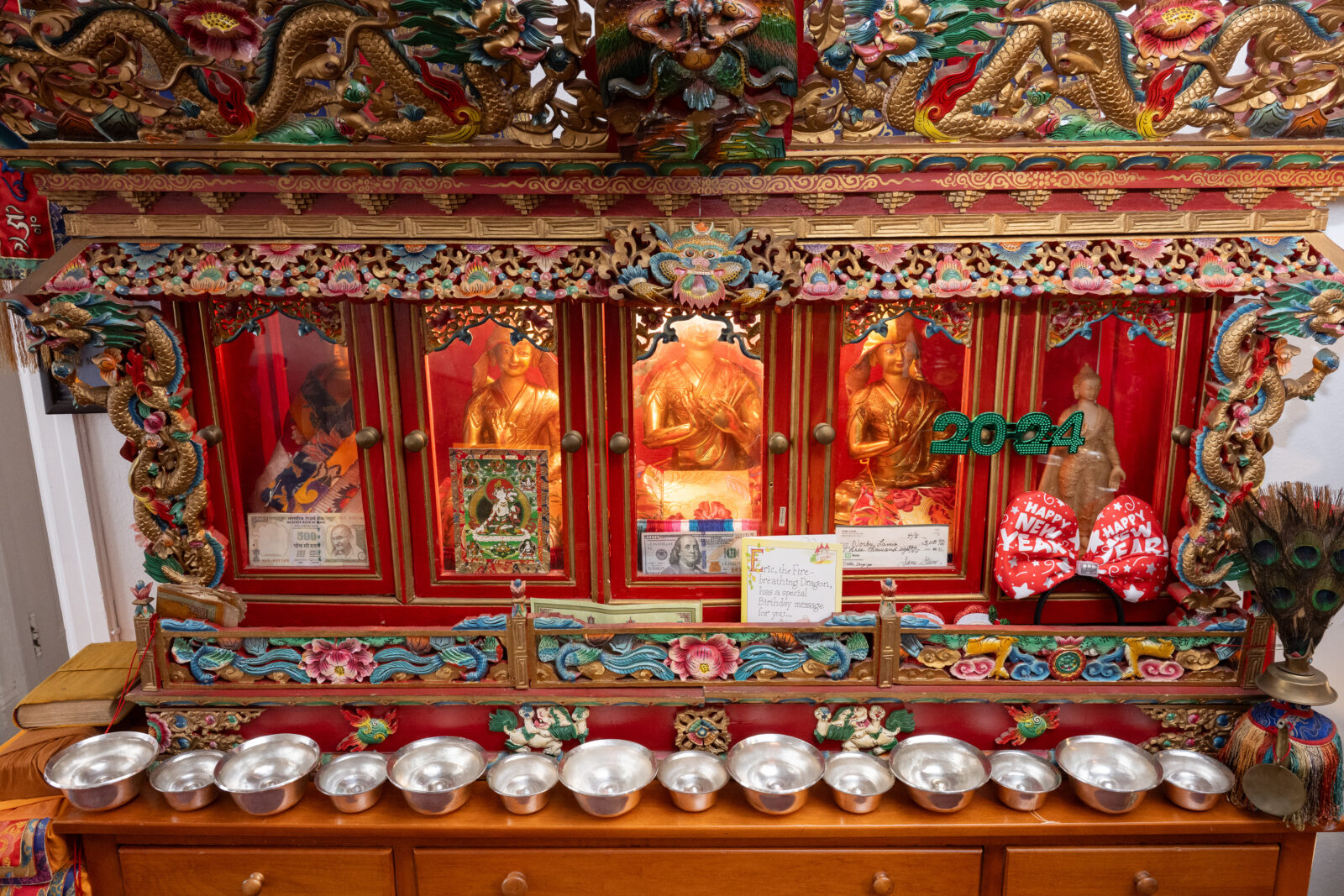 offering bowls on a cabinet in a personal shrine room