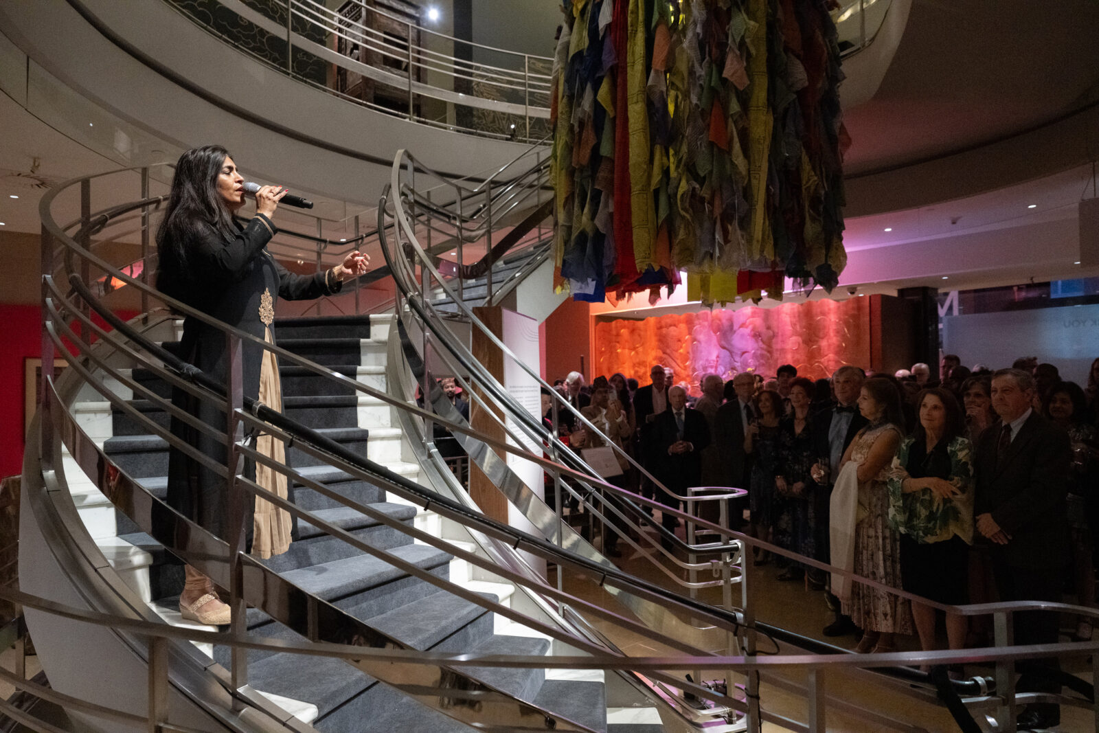 Singer and songwriter Falu singing with a microphone at the Rubin Museum