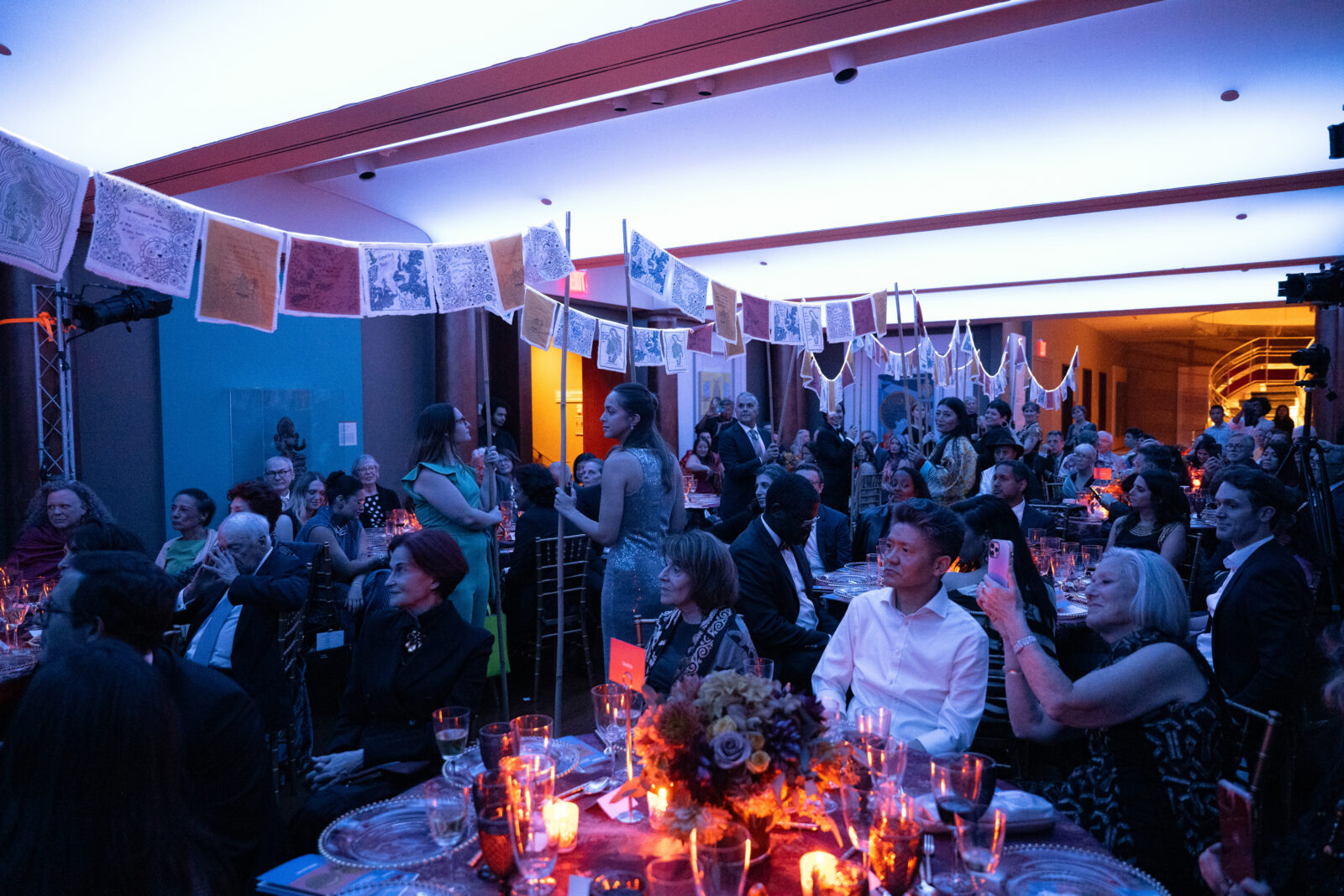 Rubin staff carrying prayer flags at the Rubin's 20th Anniversary Gala