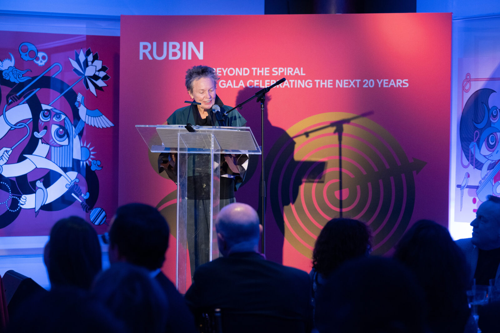 Laurie Anderson speaking from the stage at the Rubin Museum