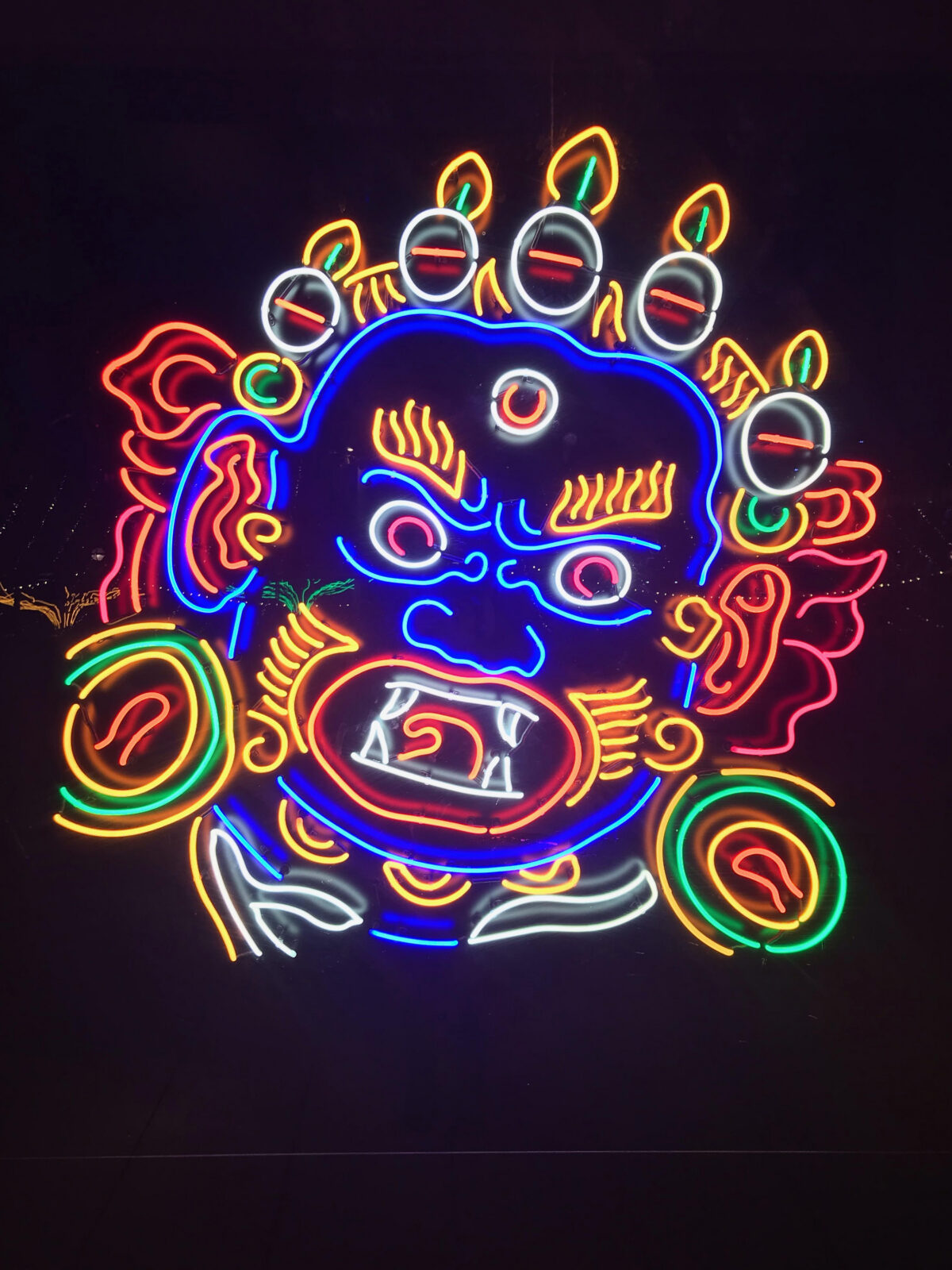 close up of a sculpture made out of various neon lights of Mahakala