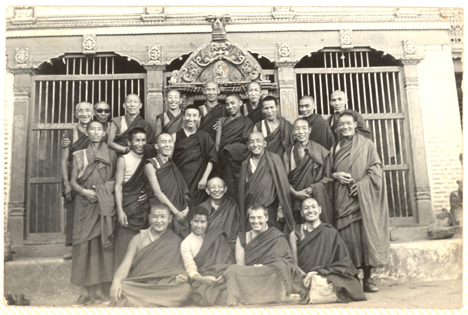 black and white photo of a group of buddhist monks and nuns, smiling