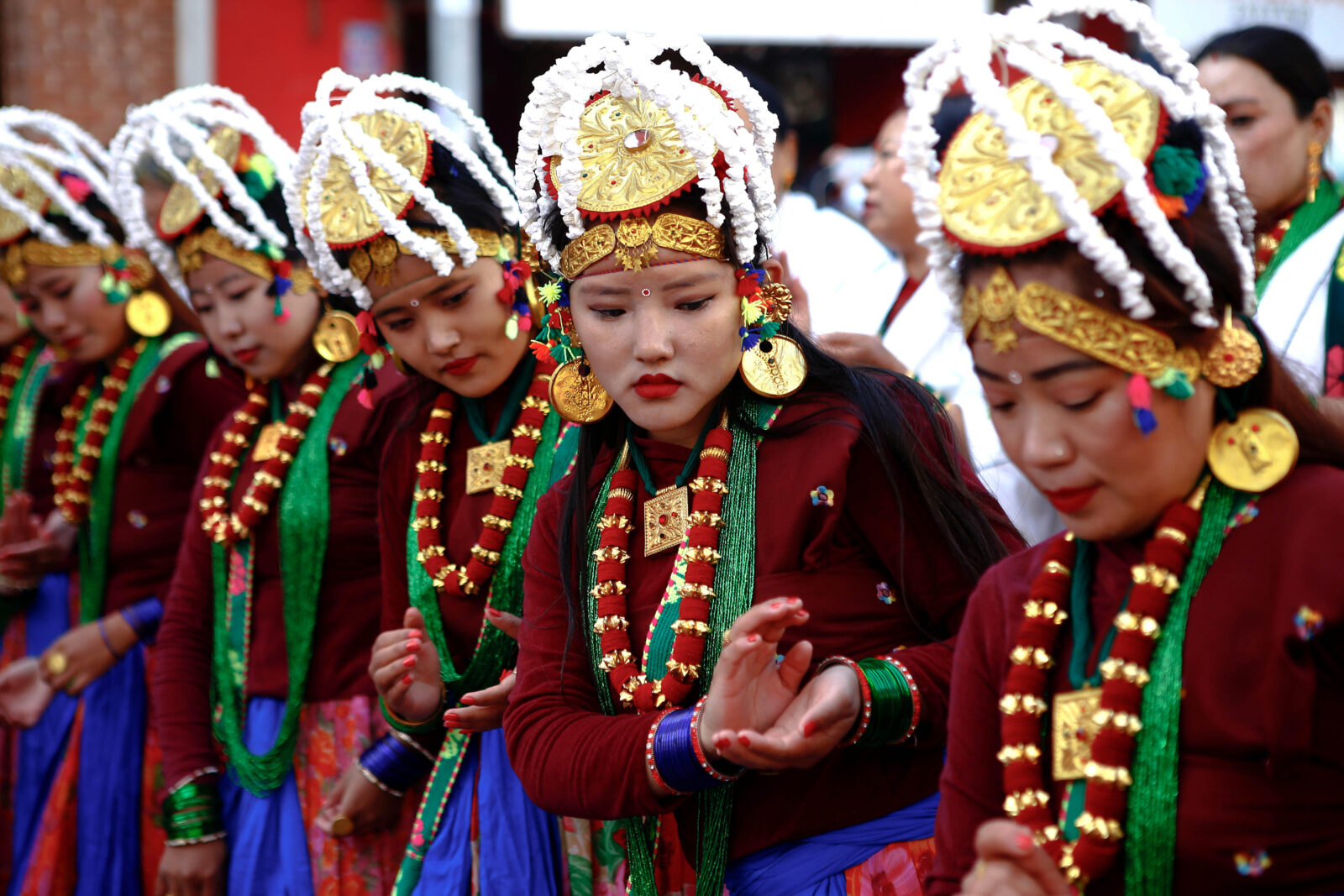 women from the Gurung community in traditional clothing dance together