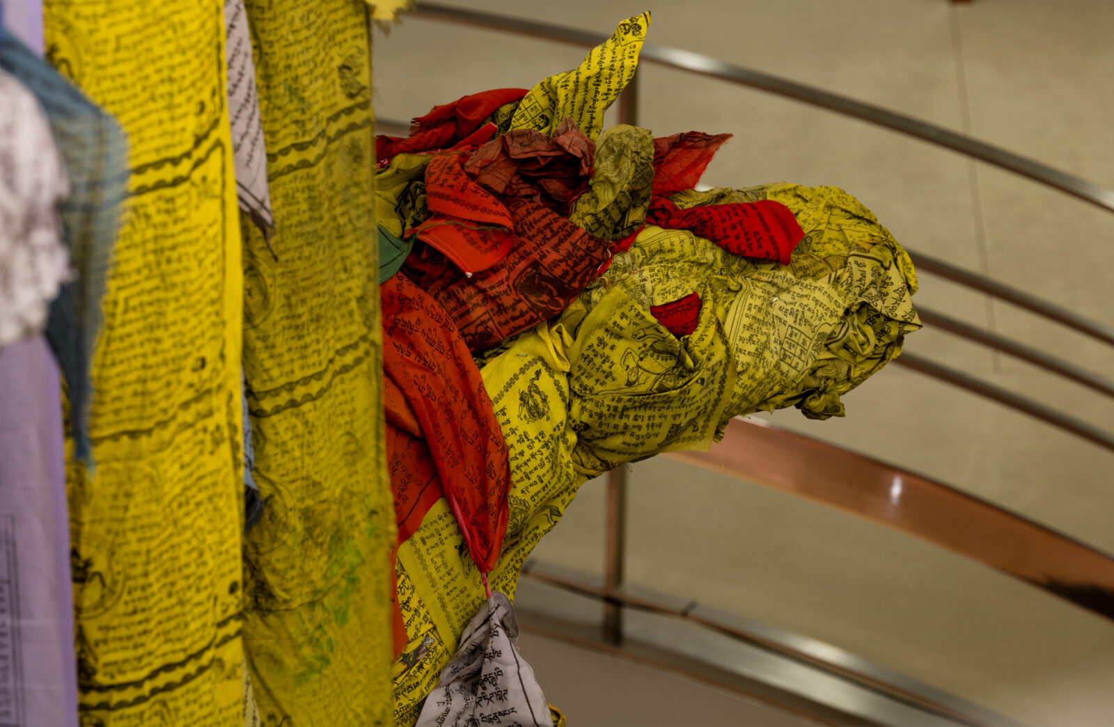 Prayer flags sculpted to take the form of a horse head with red and yellow flags.