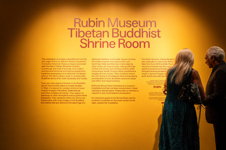 visitors looking at well text of the rubin museum tibetan buddhist shrine room at the brooklyn museum